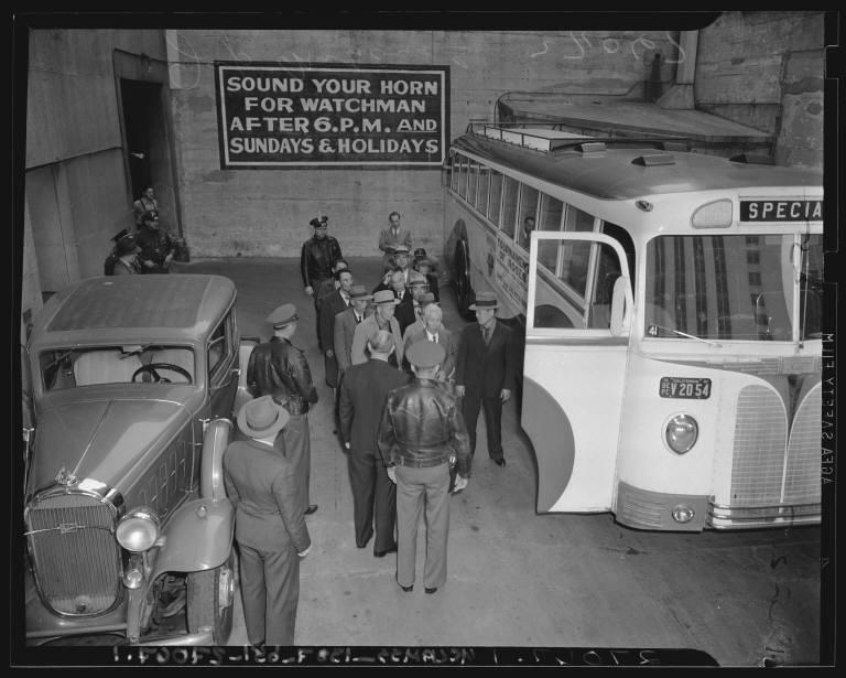 Japanese American men being loaded onto buses after being arrested in the aftermath of Pearl Harbor.